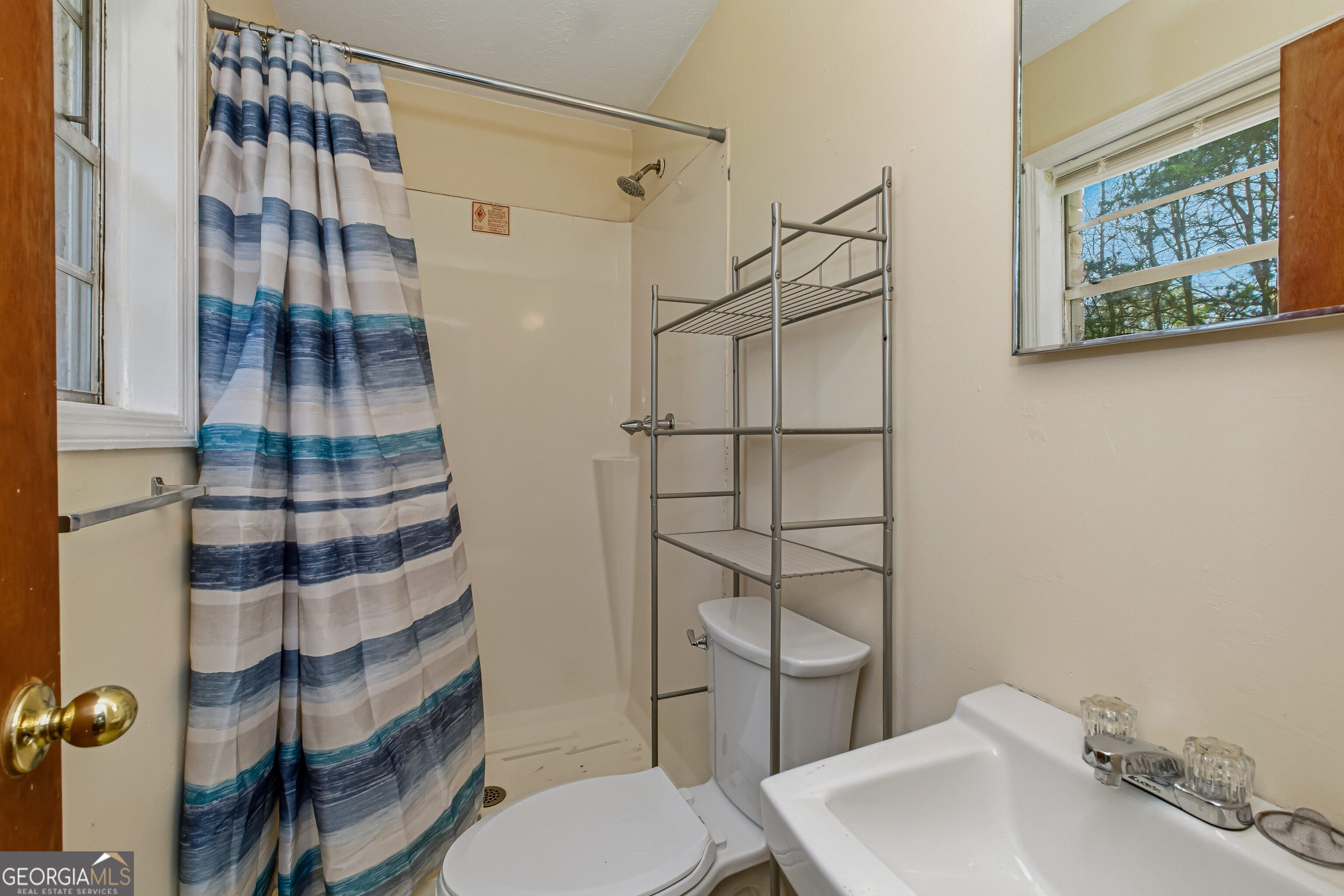 4124 Mangum Mill Road Gainesville, GA 30507 - Photo 27 of 48 a bathroom with a sink toilet and shower