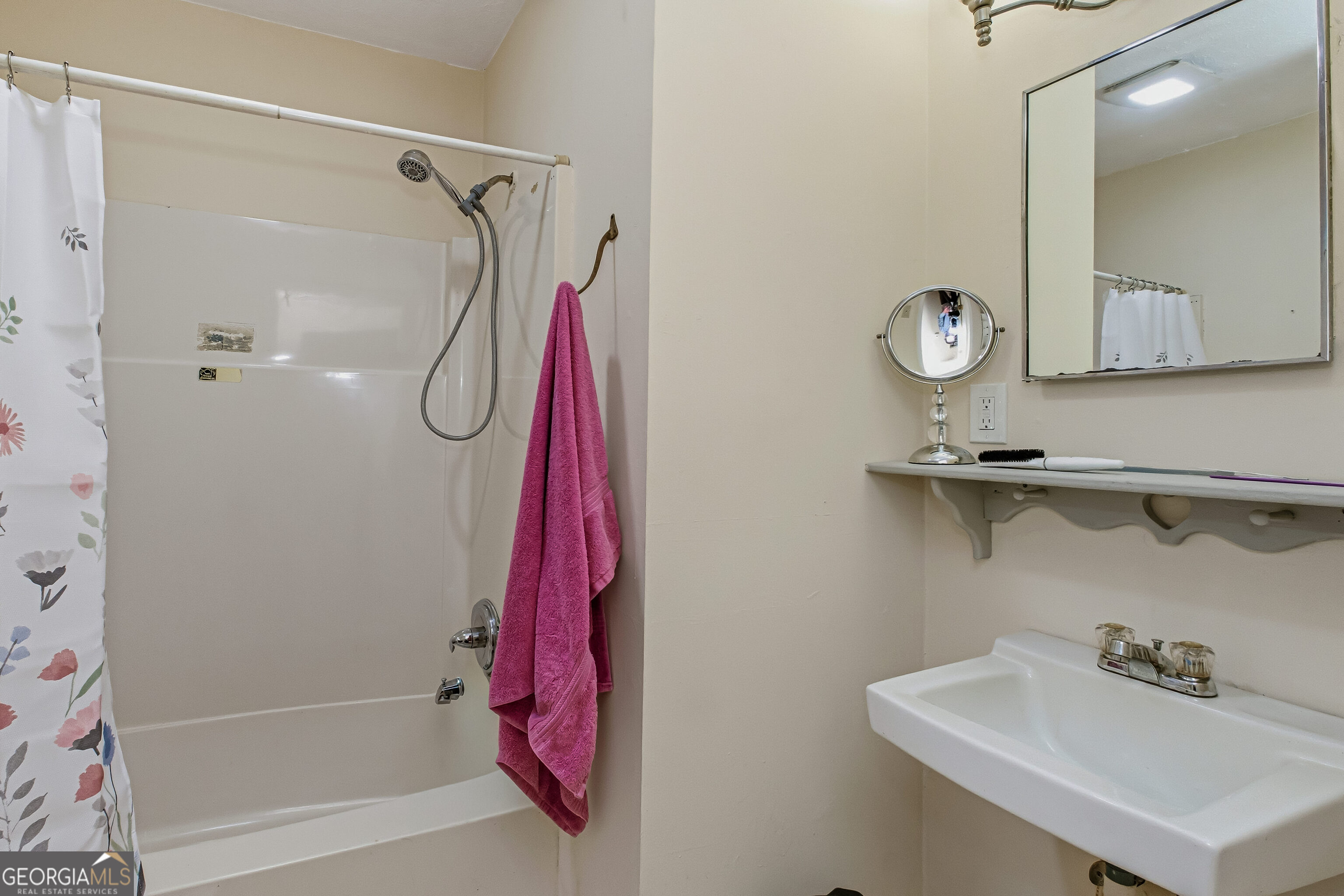 4124 Mangum Mill Road Gainesville, GA 30507 - Photo 29 of 48 a bathroom with a sink a shower and a mirror
