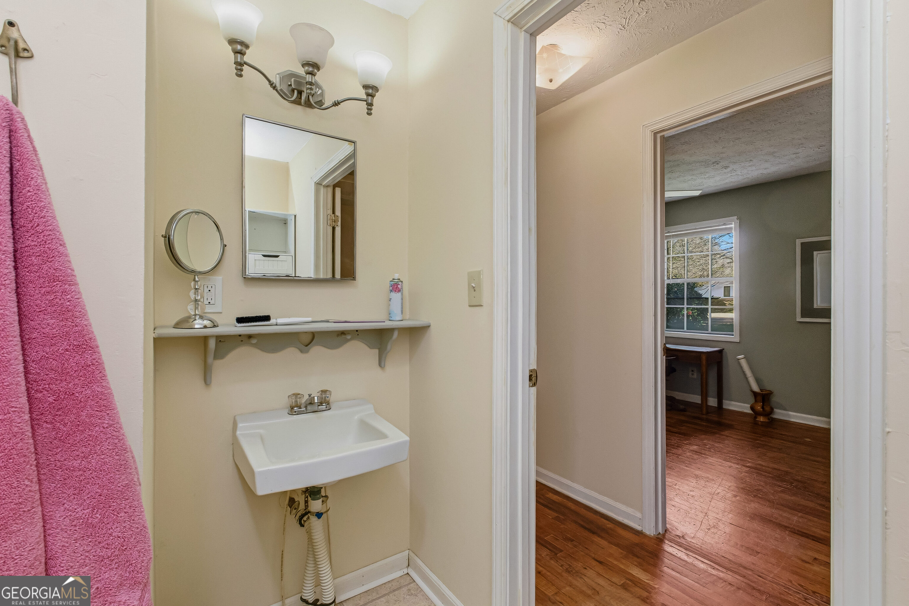 4124 Mangum Mill Road Gainesville, GA 30507 - Photo 30 of 48 a bathroom with a sink and a mirror