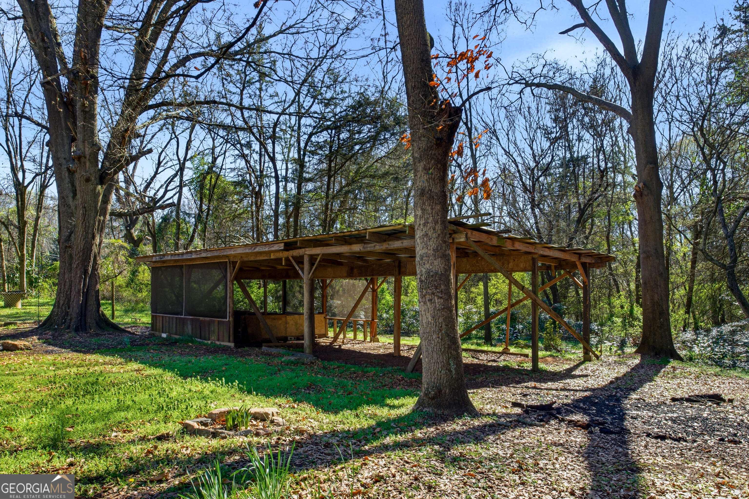 4124 Mangum Mill Road Gainesville, GA 30507 - Photo 31 of 48 a view of a backyard with wooden fence and a large tree