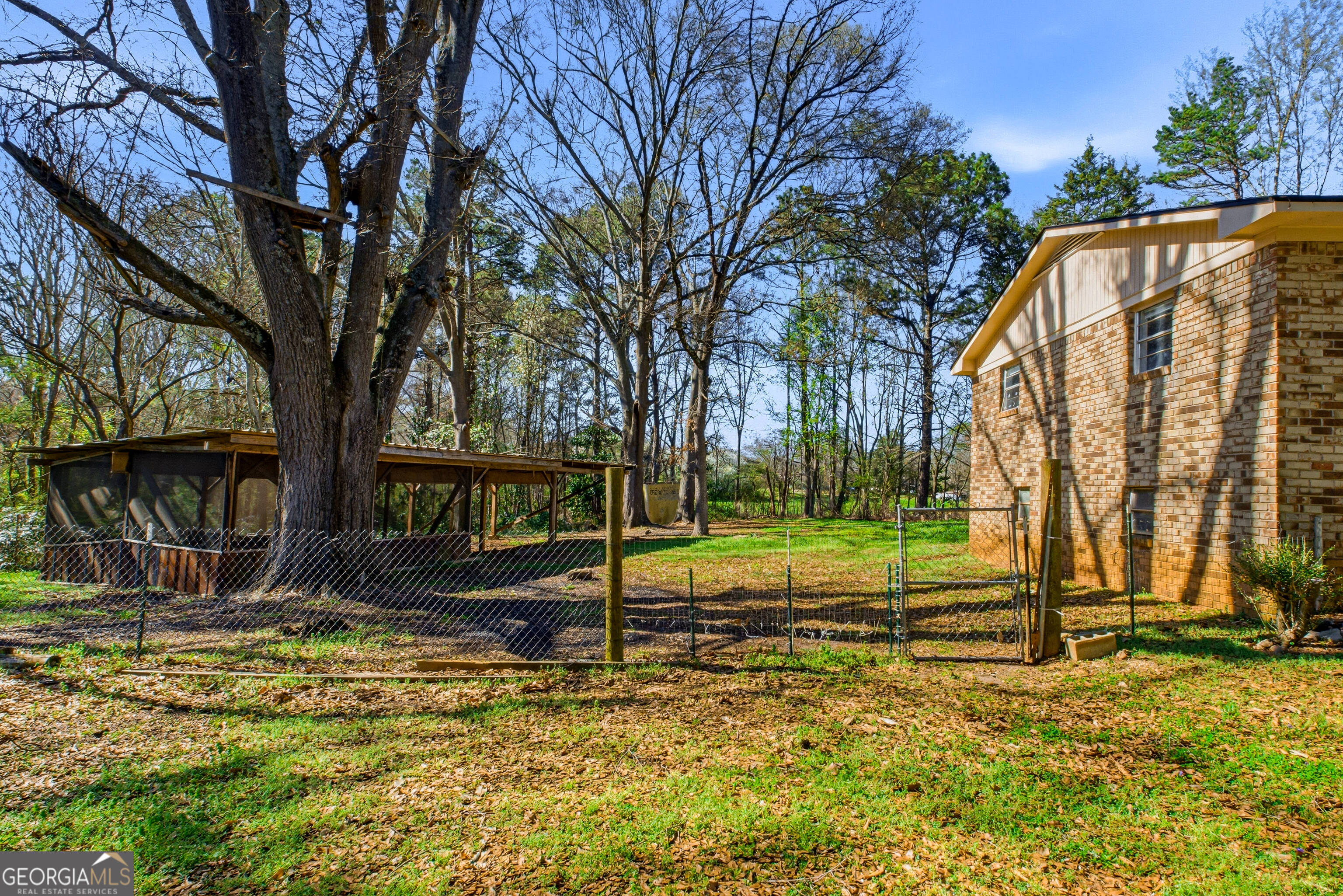 4124 Mangum Mill Road Gainesville, GA 30507 - Photo 36 of 48 a view of a house with backyard and trees