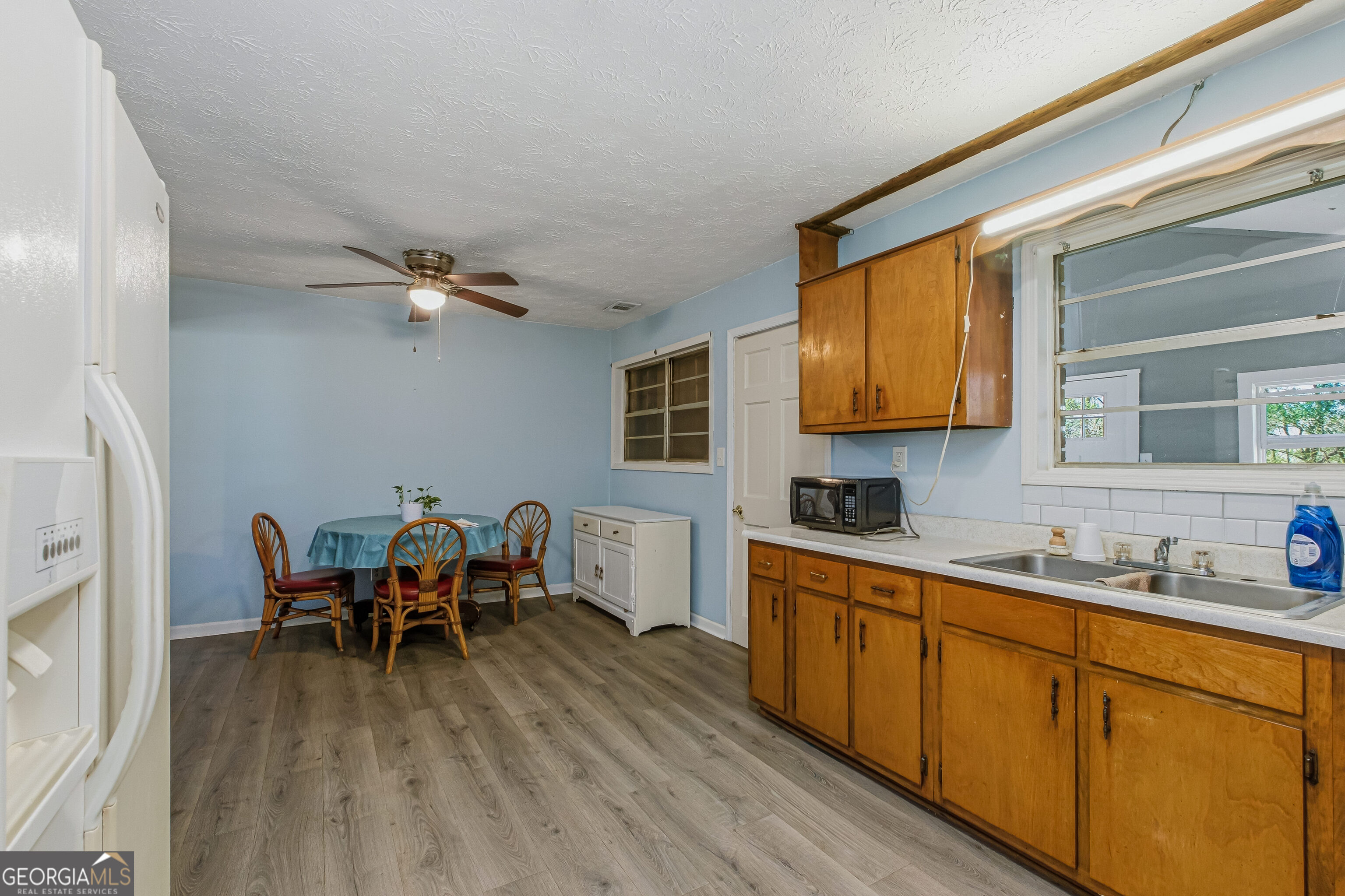 4124 Mangum Mill Road Gainesville, GA 30507 - Photo 8 of 48 a kitchen with stainless steel appliances granite countertop a sink dishwasher a stove refrigerator and cabinets with wooden floor