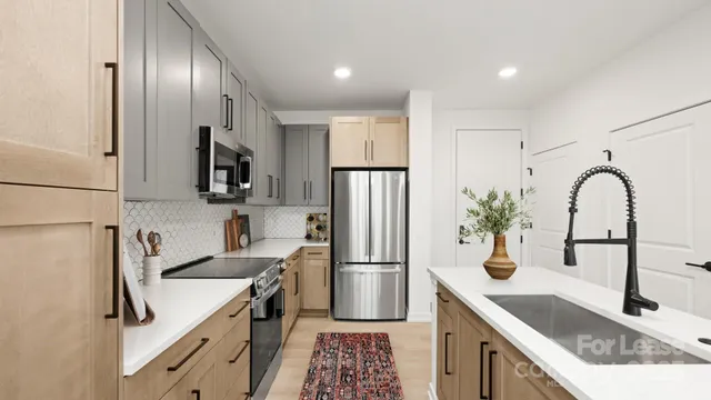 a kitchen with stainless steel appliances granite countertop a sink stove and refrigerator
