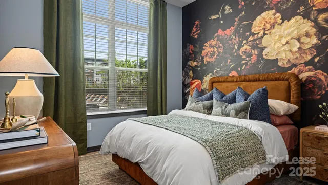 a bed sitting in a bedroom next to a window