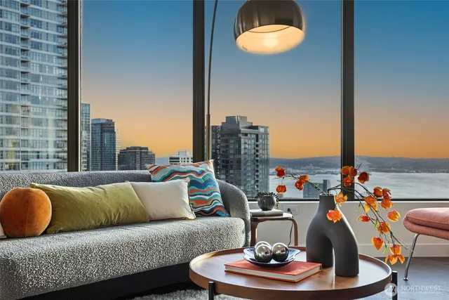 a living room with furniture and a floor to ceiling window