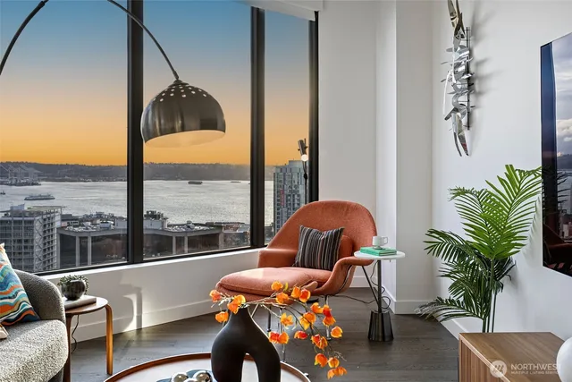 a sitting area with furniture and floor to ceiling window