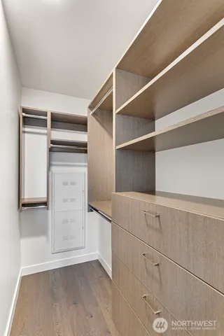 a view of walk in closet with empty racks