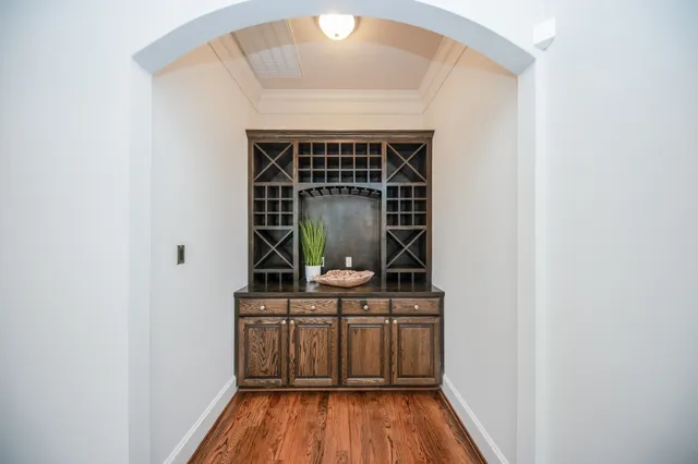 a view of a hallway with wooden floor and entryway