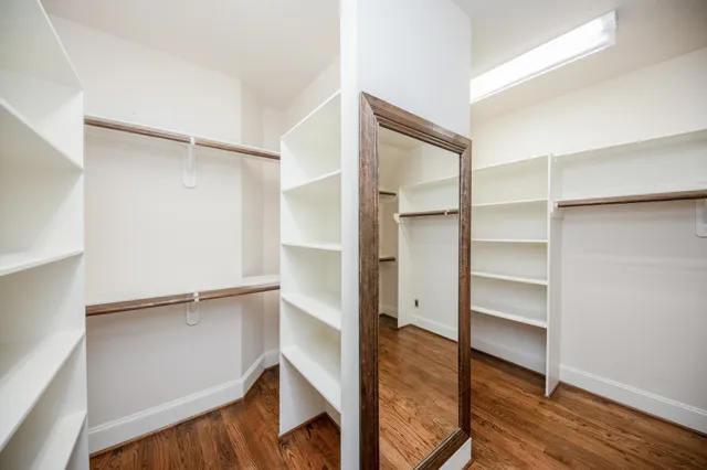 a view of walk in closet with empty racks