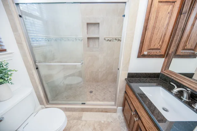 a bathroom with a sink a toilet and a shower