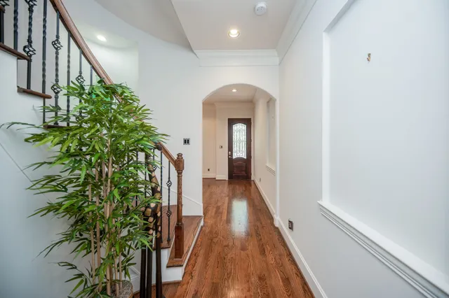 view of a hallway with wooden floor and plant