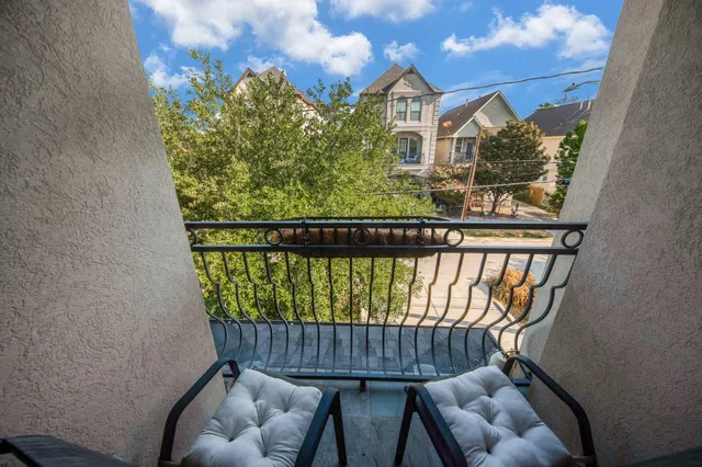 a view of a balcony with chairs