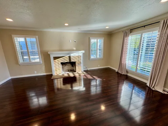 a living room with fireplace furniture and a wooden floor