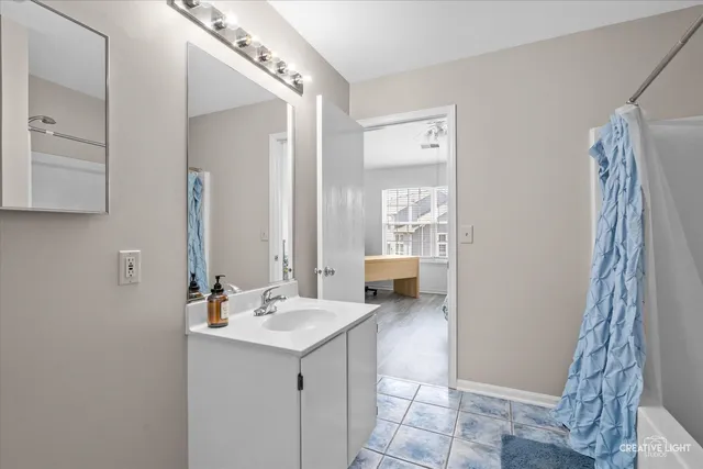 a bathroom with a sink a mirror and a shower