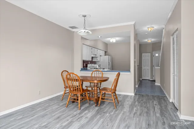 a view of a dining room with furniture and wooden floor