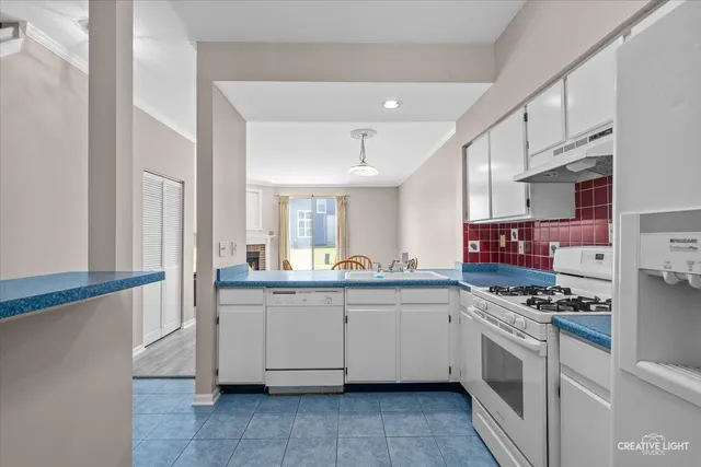 a kitchen with stainless steel appliances granite countertop a sink and cabinets