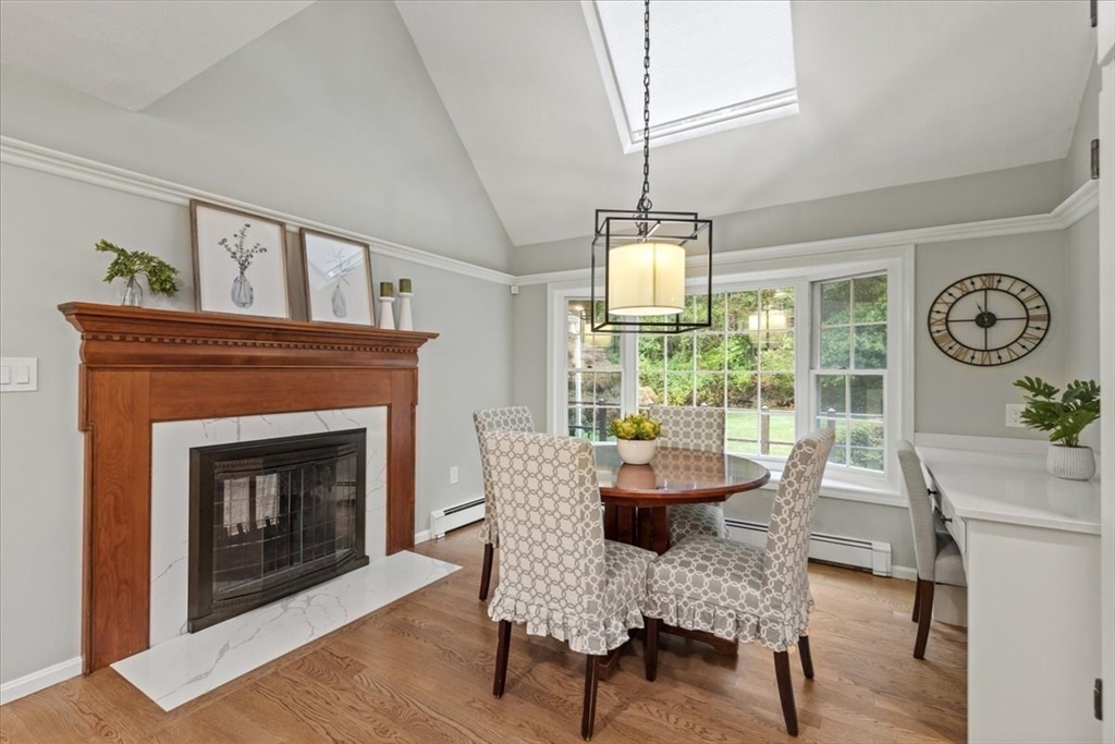 74 Granite Street Walpole, MA 02052 - Photo 12 of 40 a dining room with furniture a fireplace and wooden floor