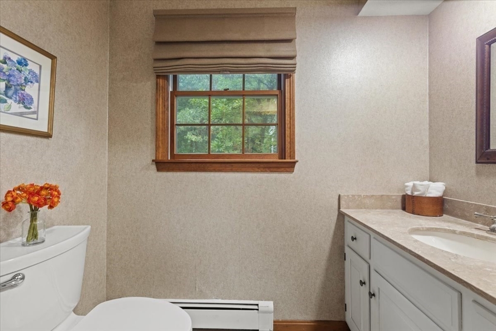 74 Granite Street Walpole, MA 02052 - Photo 15 of 40 a bathroom with a granite countertop toilet and a sink