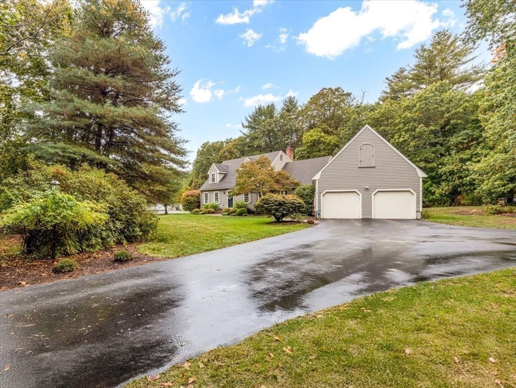 74 Granite Street Walpole, MA 02052 - Photo 2 of 40 a front view of a house with a yard and garage