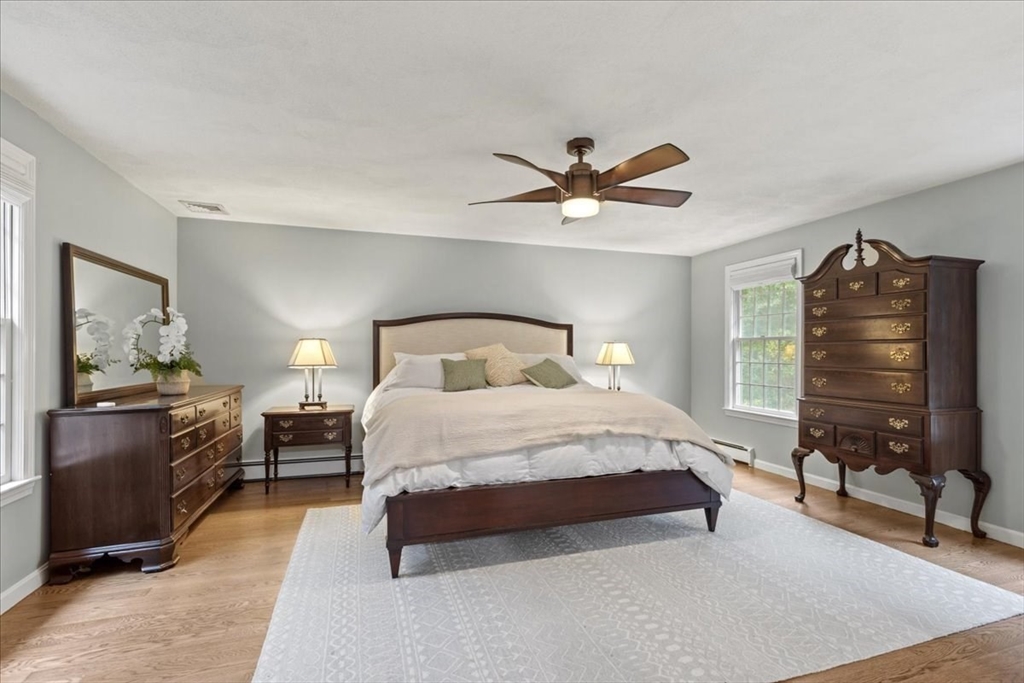 74 Granite Street Walpole, MA 02052 - Photo 21 of 40 a bedroom with a bed and a chandelier