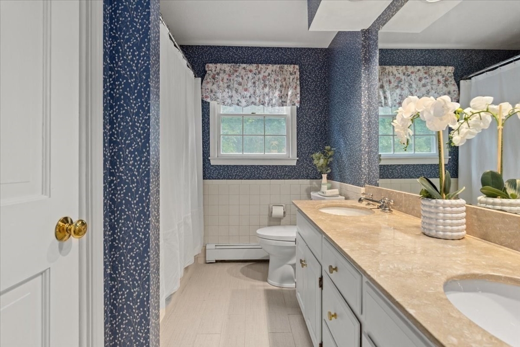 74 Granite Street Walpole, MA 02052 - Photo 30 of 40 a bathroom with a granite countertop sink a toilet and a shower