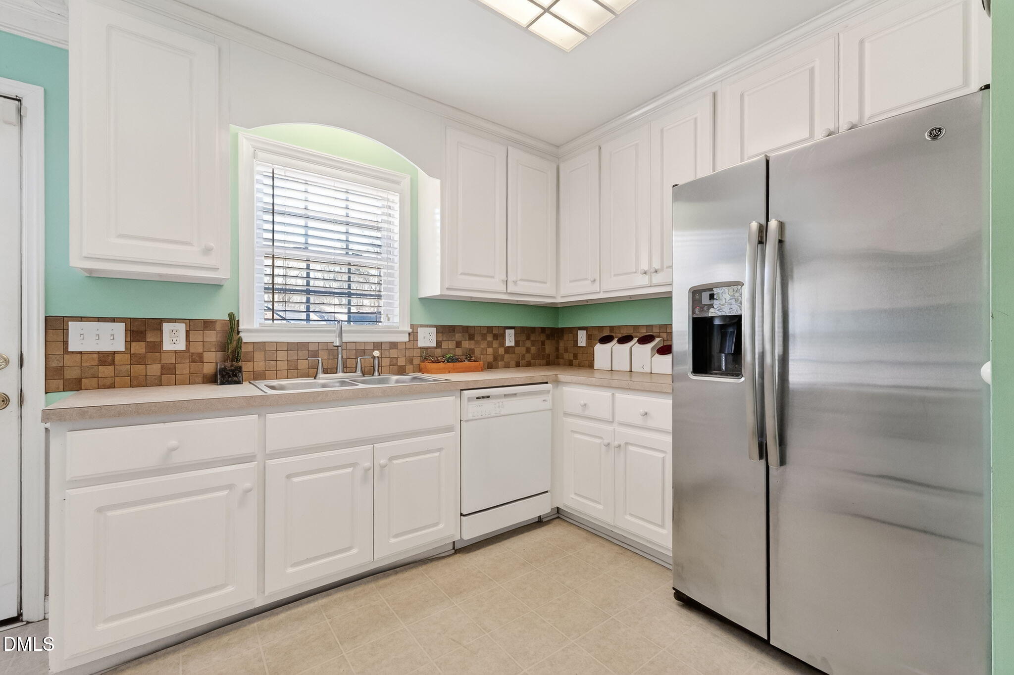 305 River Birch Run Coats, NC 27521 - Photo 11 of 36 a kitchen with granite countertop white cabinets and refrigerator