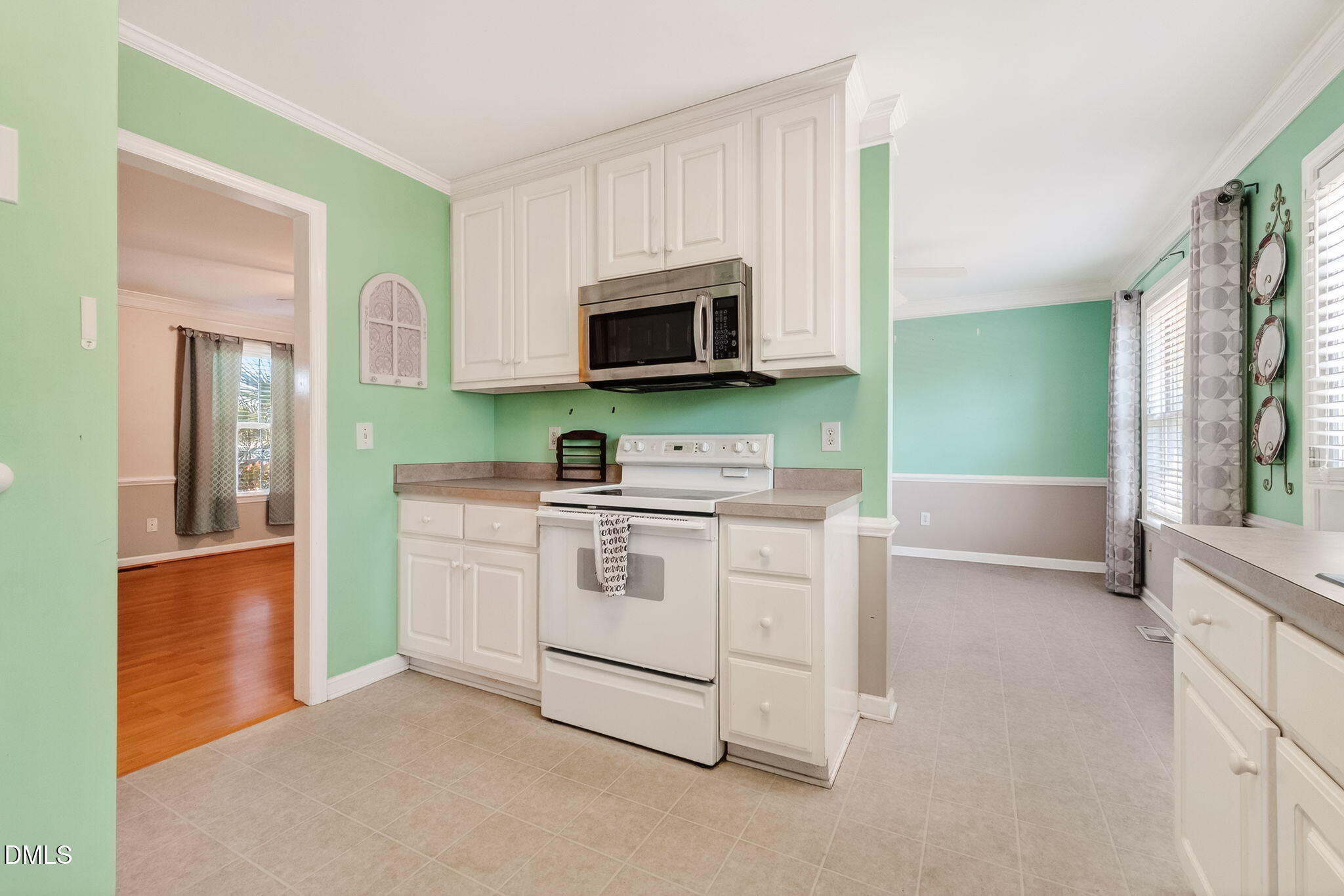 305 River Birch Run Coats, NC 27521 - Photo 12 of 36 a kitchen with stainless steel appliances granite countertop a stove a sink and a microwave