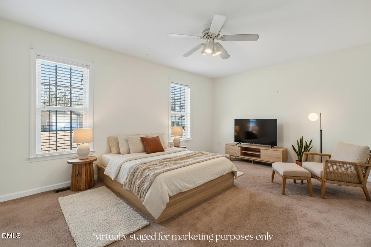 305 River Birch Run Coats, NC 27521 - Photo 17 of 36 a bedroom with a bed and a flat screen tv