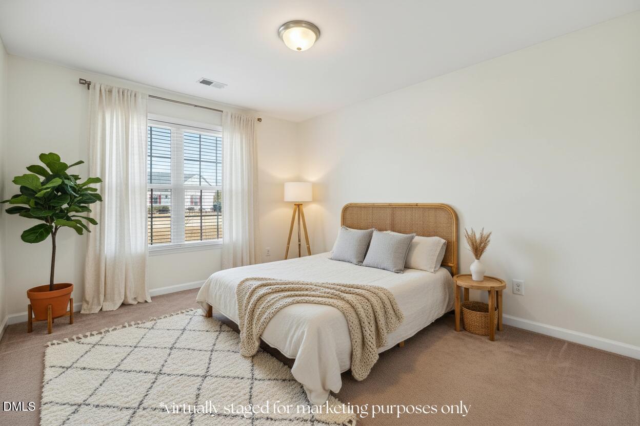 305 River Birch Run Coats, NC 27521 - Photo 24 of 36 a bedroom with a bed and a window