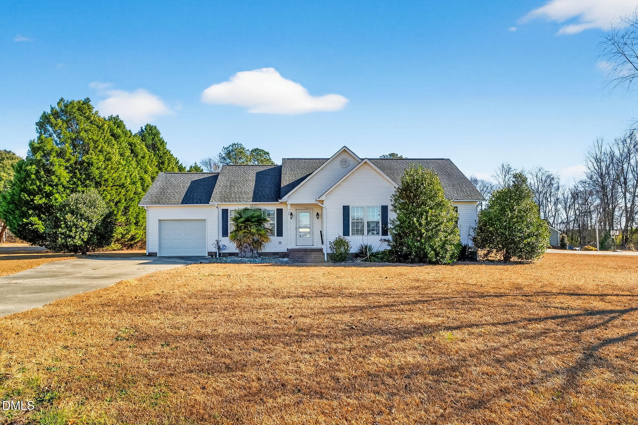 305 River Birch Run Coats, NC 27521 - Photo 4 of 36 a front view of a house with a yard and garage