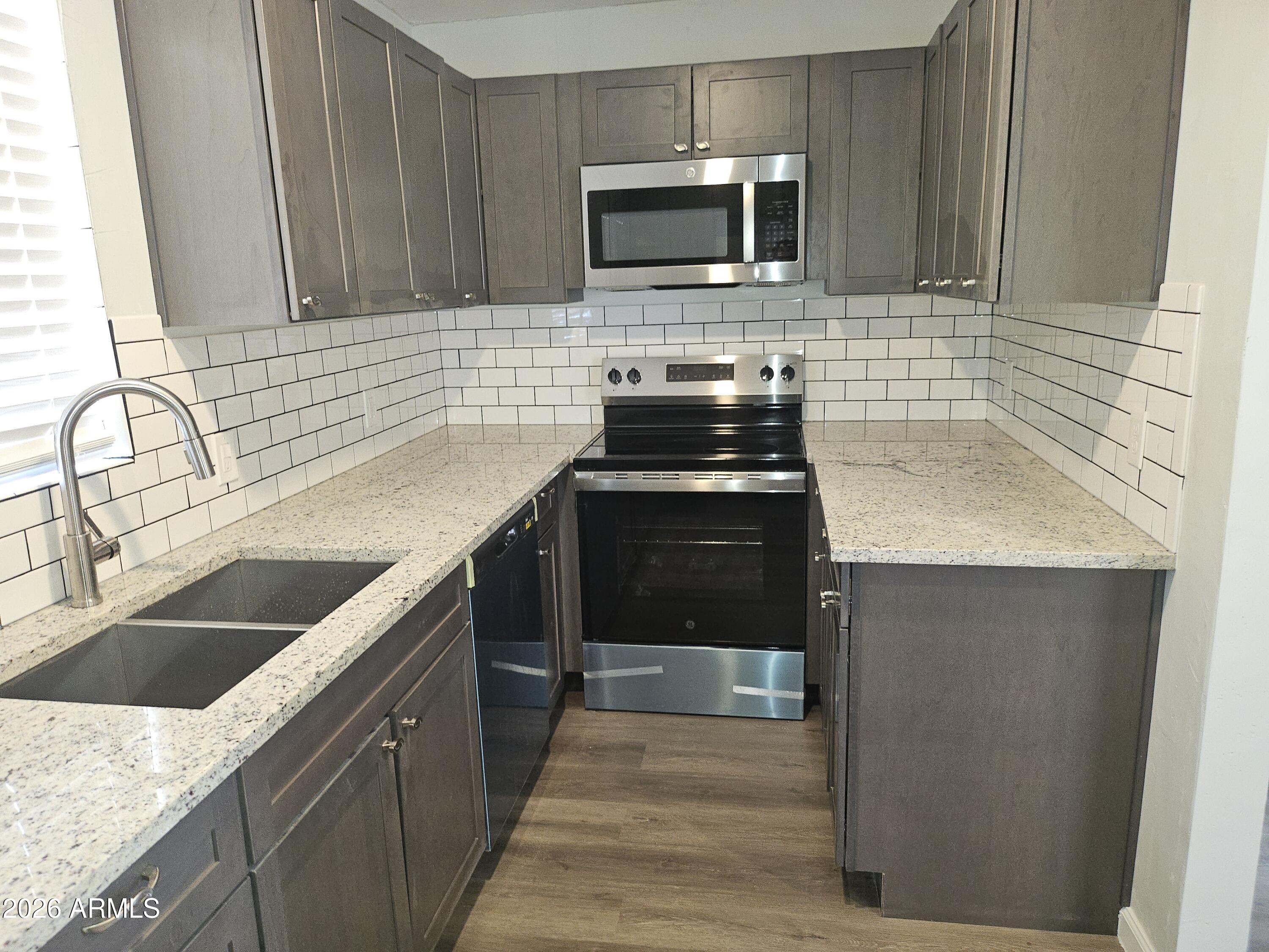 524 West 3rd Place Mesa, AZ 85201 - Photo 5 of 23 a kitchen with a sink stove and microwave