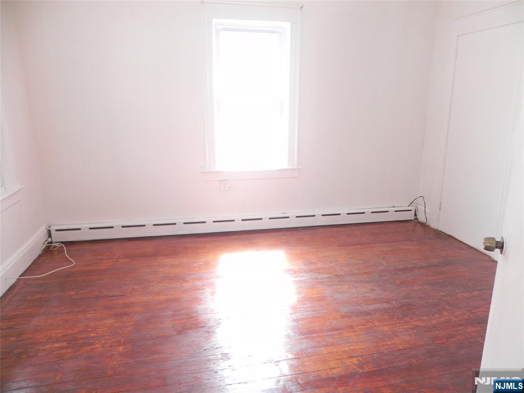 33 Center Street, Unit 1 Little Ferry, NJ 07643 - Photo 6 of 12 a view of a room with wooden floor and a window