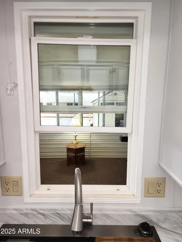 a view of a patio with table and chairs