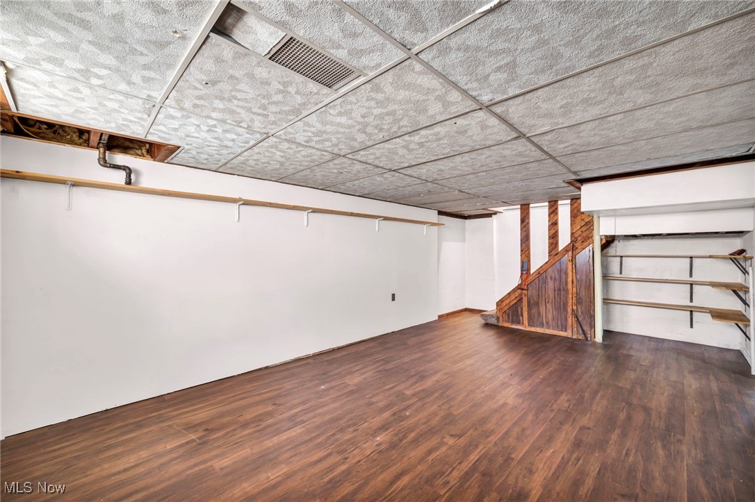 7822 Ridgefield Avenue Parma, OH 44129 - Photo 22 of 42 Finished basement featuring dark wood-type flooring and a drop ceiling