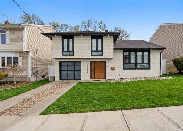 a front view of a house with a garden