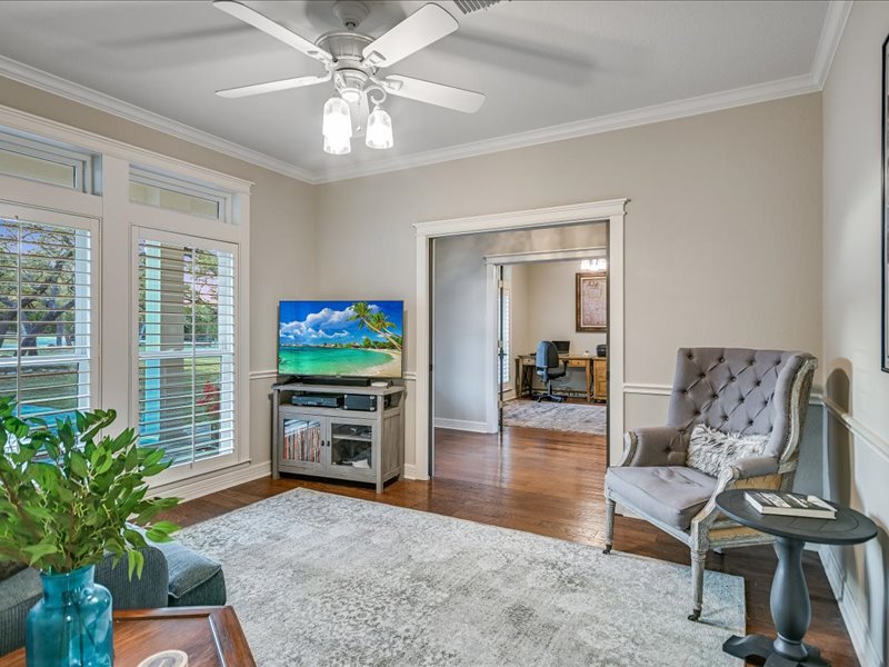 14036 Timberline Trail Austin, TX 78737 - Photo 11 of 40 This room is adjacent to the kitchen and foyer. It could be used as a dining or living room. Wood floors, crown molding, large windows overlooking front yard.