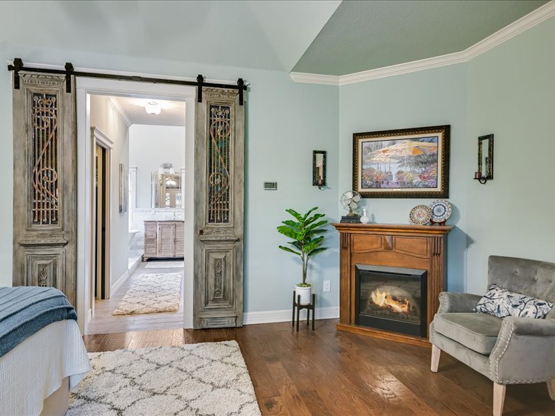 14036 Timberline Trail Austin, TX 78737 - Photo 14 of 40 Bedroom featuring crown molding, wood flooring, a barn door to main bathroom.