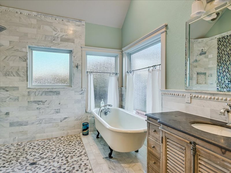 14036 Timberline Trail Austin, TX 78737 - Photo 16 of 40 Main bath with vanity, a tile shower, a freestanding tub, healthy amount of natural light, and vaulted ceiling.