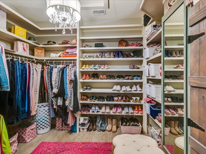 14036 Timberline Trail Austin, TX 78737 - Photo 17 of 40 Main bedroom has custom walk-in closet with a chandelier. 2nd closet across hallway that connects these rooms to the main bedroom and bath.