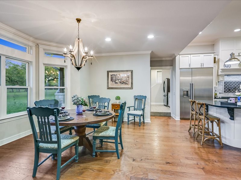 14036 Timberline Trail Austin, TX 78737 - Photo 8 of 40 Breakfast room is adjacent to kitchen and living room. Wood flooring, bay window and crown molding.