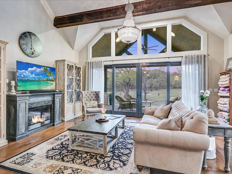 14036 Timberline Trail Austin, TX 78737 - Photo 9 of 40 Living room featuring a glass covered fireplace, wood finished floors, and ceiling fan