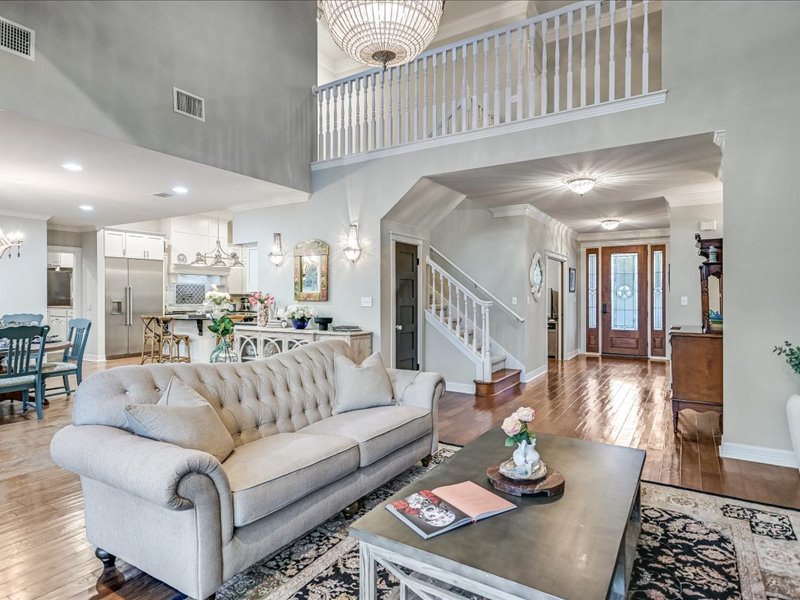 14036 Timberline Trail Austin, TX 78737 - Photo 10 of 40 Living area with ornamental molding, light wood-type flooring, hanging lights, and a high ceiling