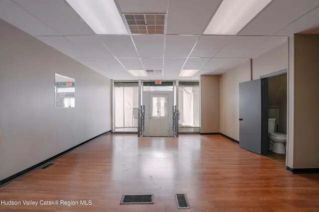 a view of a livingroom with wooden floor and a window