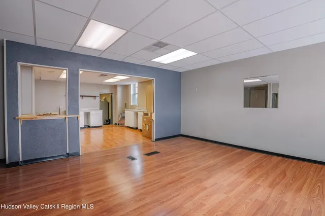 a view of a kitchen with wooden floor and electronic appliances