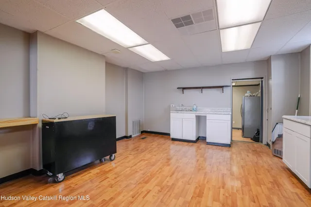 a kitchen with sink refrigerator and cabinets