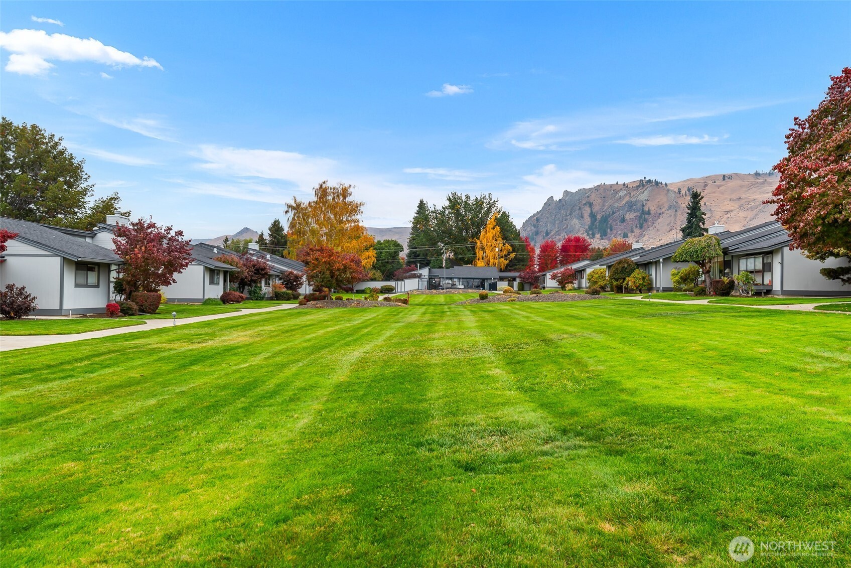 1310 Castlerock Avenue, Unit 19 Wenatchee, WA 98801 - Photo 15 of 17 a backyard of a house with table and chairs plants and large trees