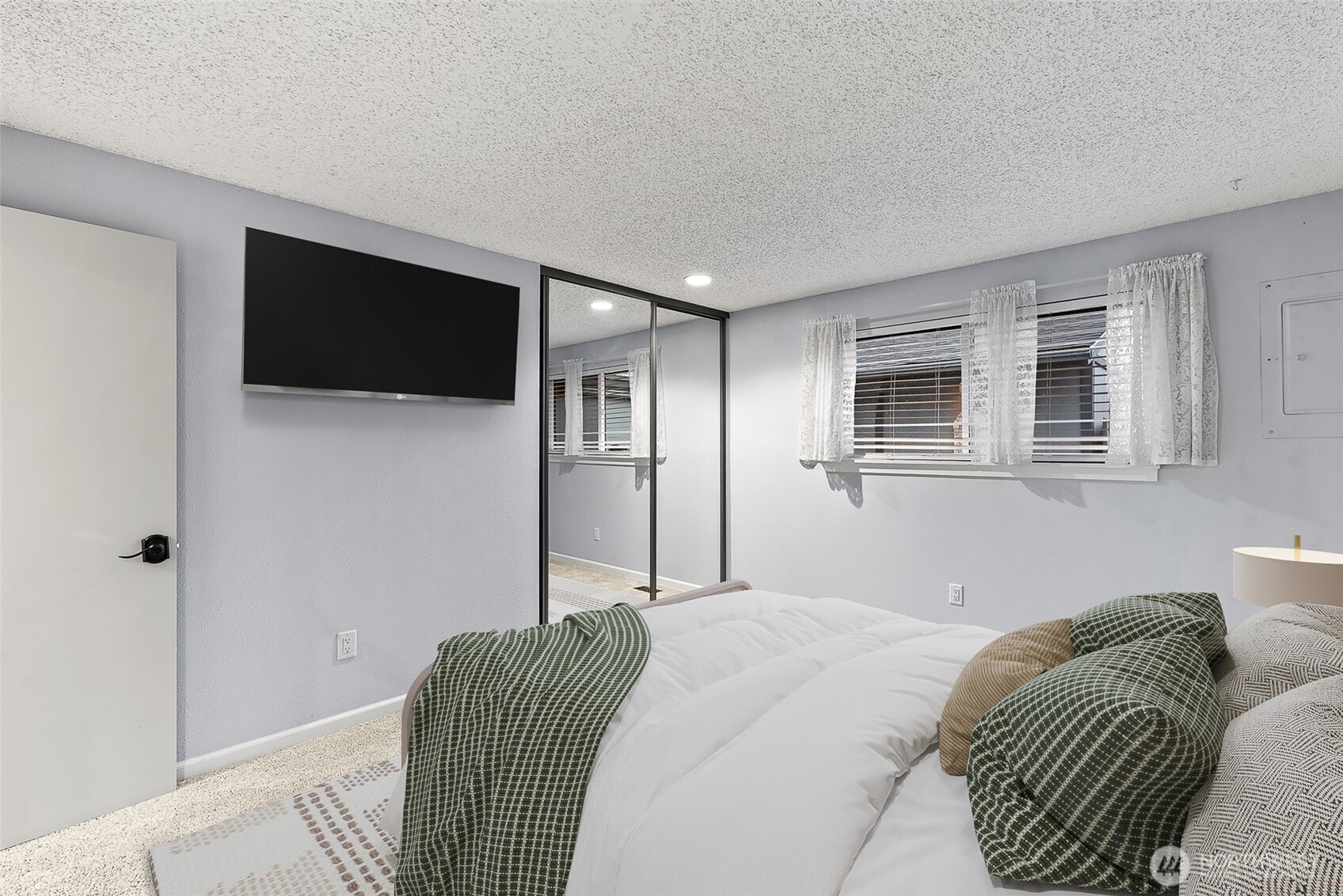 1310 Castlerock Avenue, Unit 19 Wenatchee, WA 98801 - Photo 7 of 17 a bedroom with a bed a flat screen tv and wall