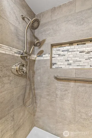 a bedroom with bed and night stand