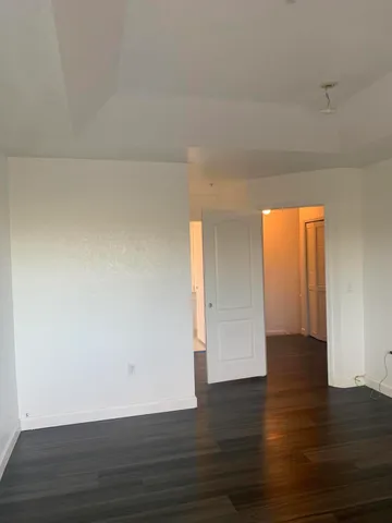 a view of an empty room and wooden floor