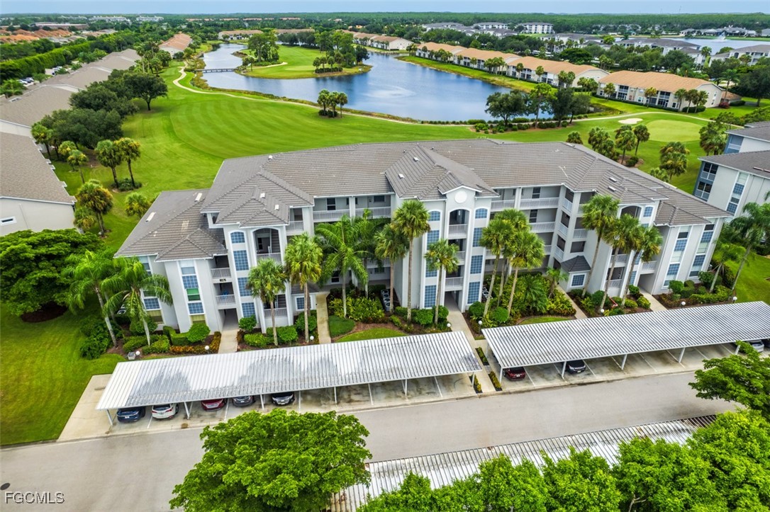 an aerial view of a house with a garden and lake view